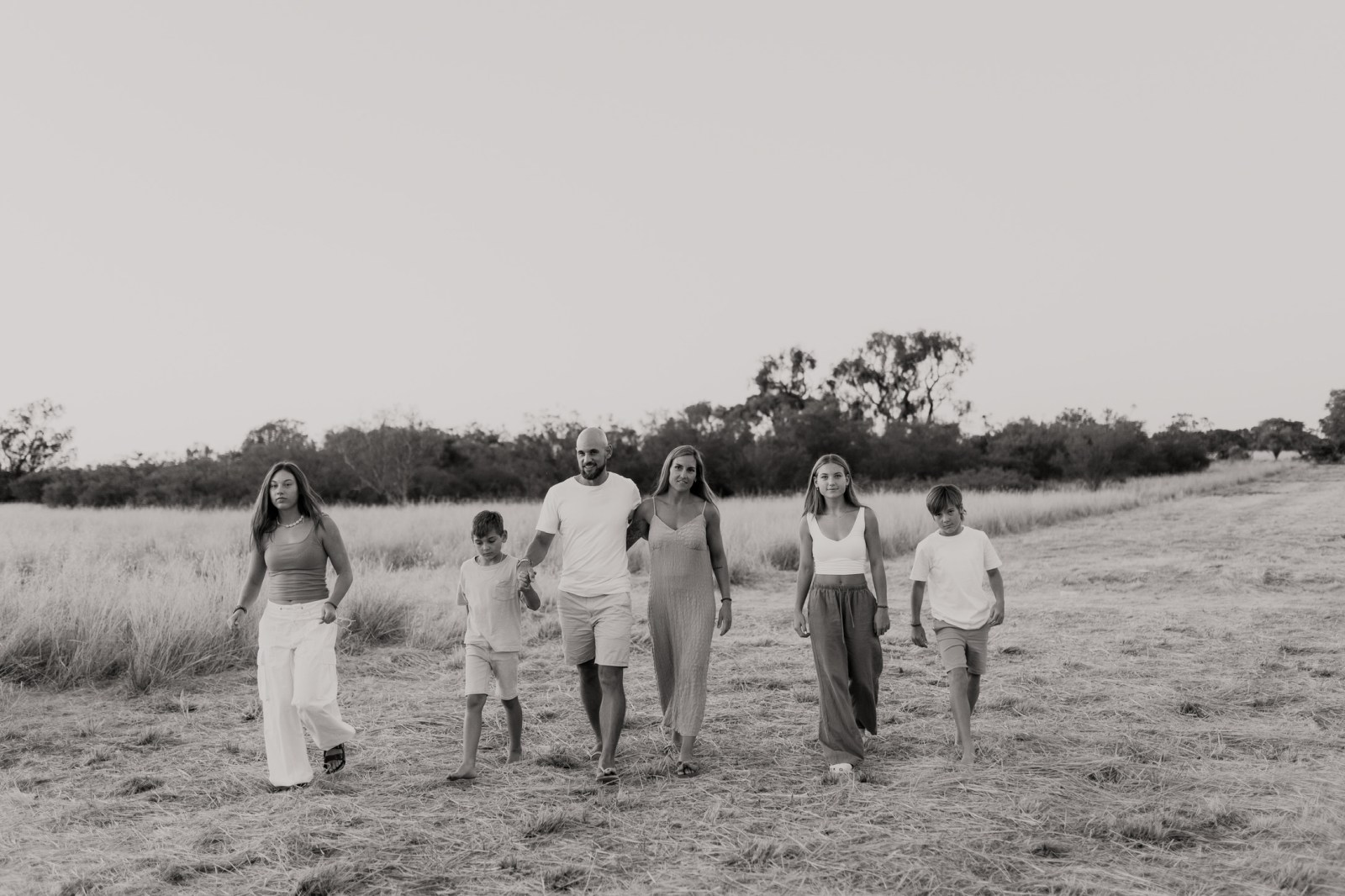 Alex Dennis and family walking through a field