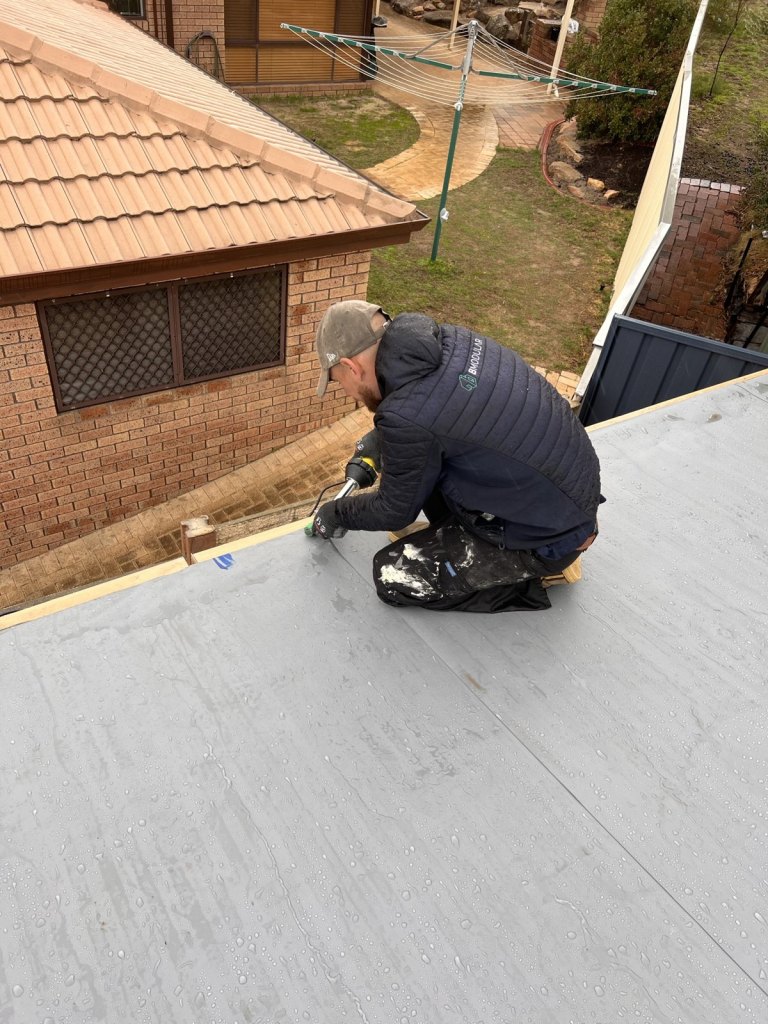 Alex Dennis heat-welding the roof membrane on the Padbury prototype