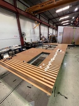 Timber-battened panel being assembled on the factory floor
