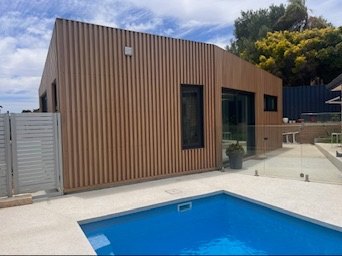 The finished Padbury prototype, a timber-clad studio beside a pool