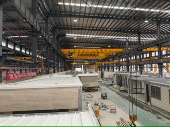 Modules in production on a large factory floor