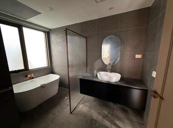Bathroom with freestanding bath and floating vanity inside a module