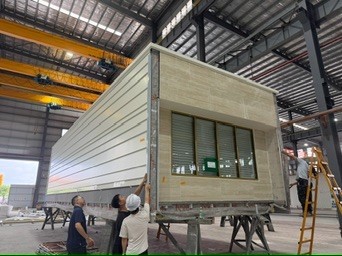Inspecting a volumetric module on trestles in the factory