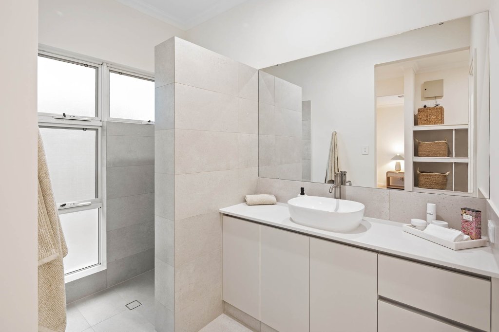 The Magnolia display home: bathroom with stone-look vanity and walk-in shower