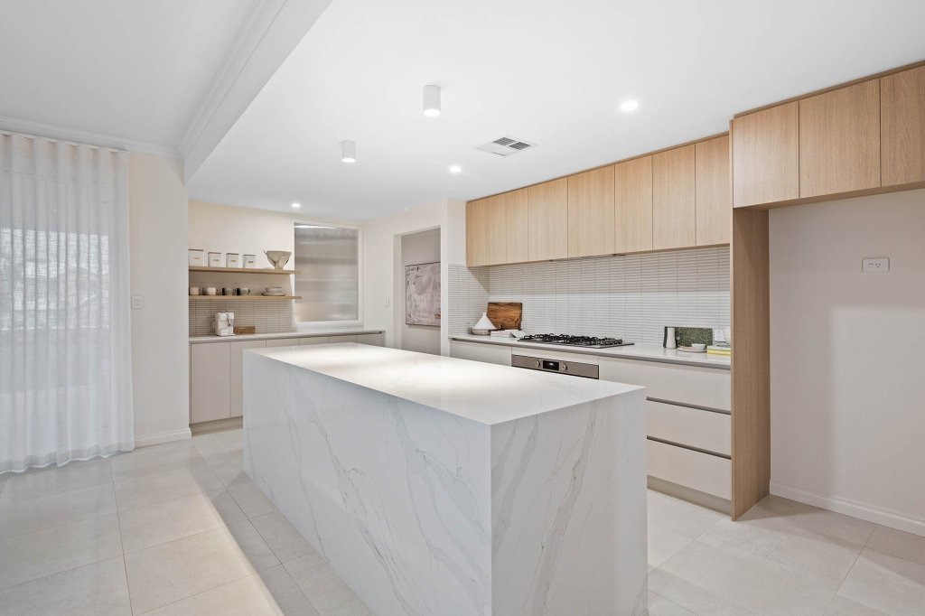 The Magnolia display home: marble-look waterfall island and timber-look overhead cabinets