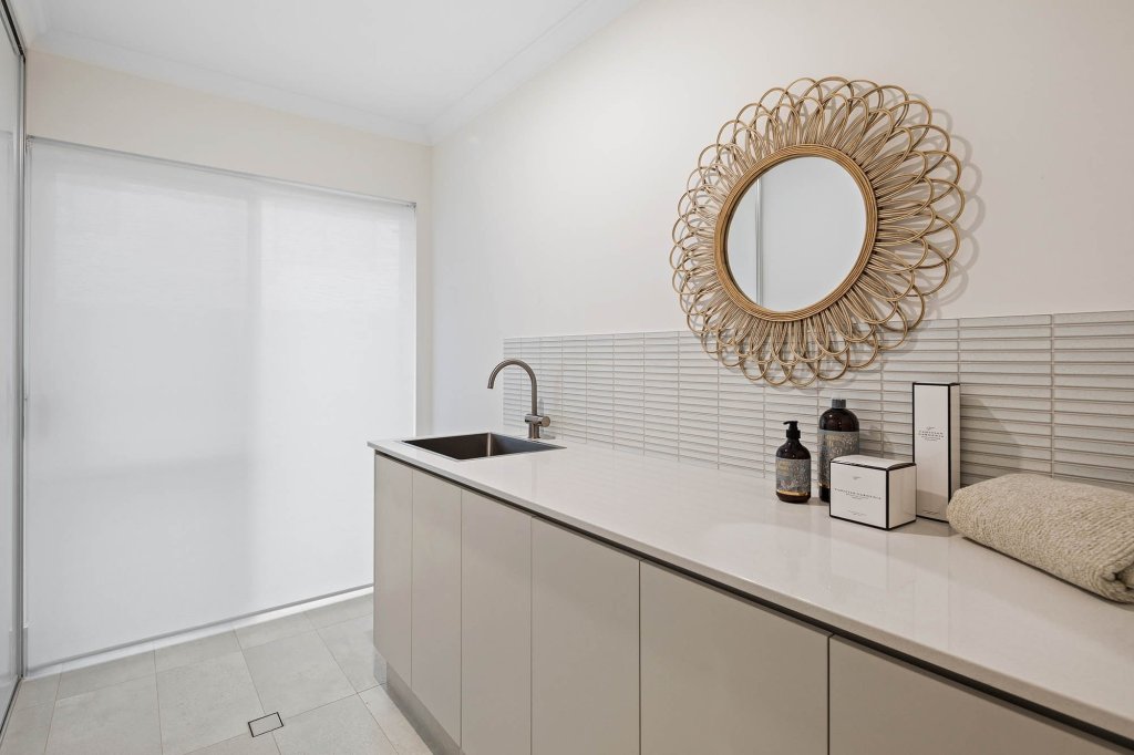 The Magnolia display home: bench and sink with tiled splashback